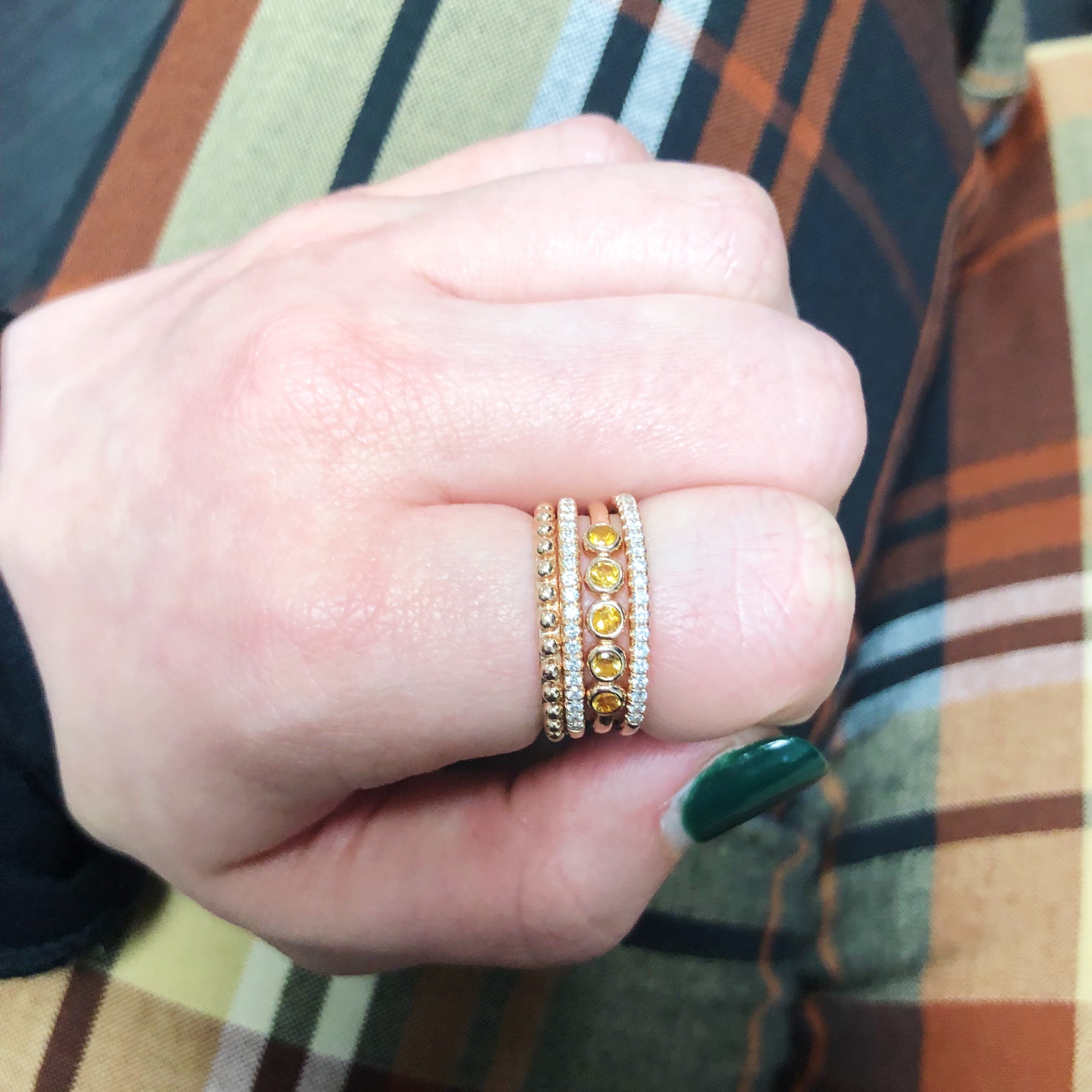 Thin banned ring with a row of diamonds beautifully stacked