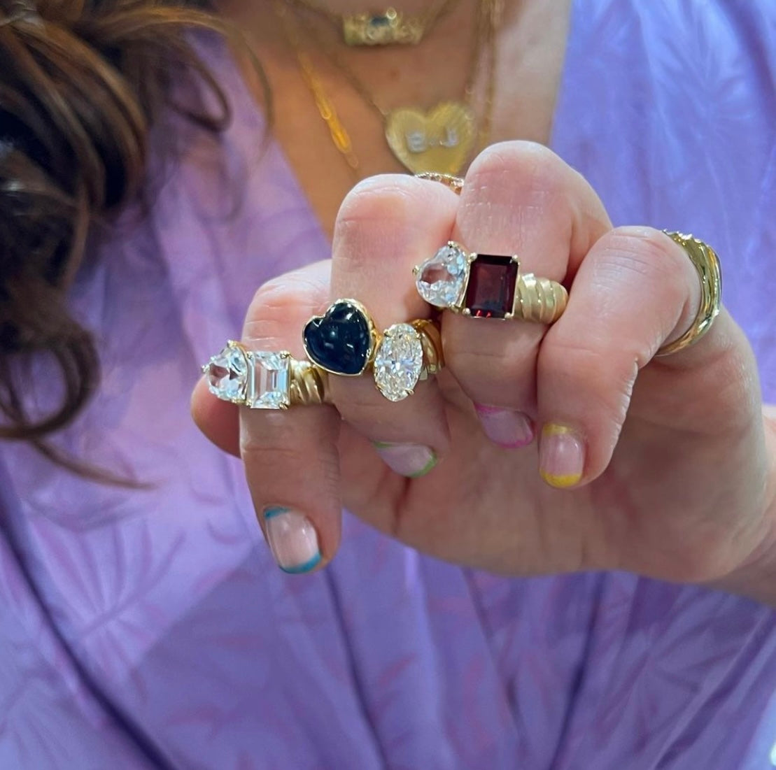Chunky wide banned yellow gold two stone ring with heart shape stone and emerald cut