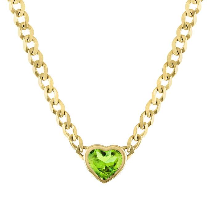 Yellow gold cuban link chain necklace with a heart shaped bezeled peridot in the center.