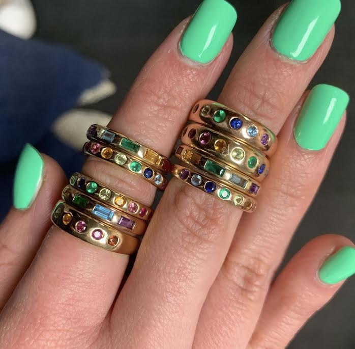 Yellow gold wide band 5 stone baguette rainbow ring layered on fingers