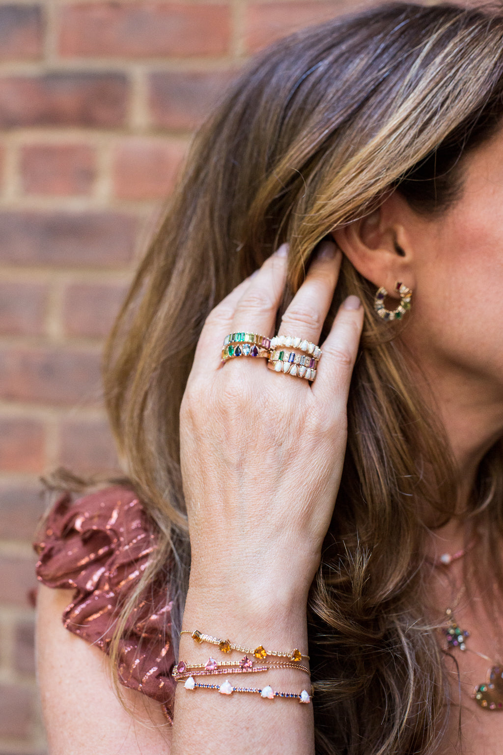 Yellow gold huggy earrings with multi color baguettes and round diamonds