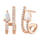 Rose gold pair of huggies with a pear shaped opal and round diamonds.