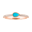 Rose gold skinny band with a bezeled pear shape turquoise in the center and round diamond on the shank.