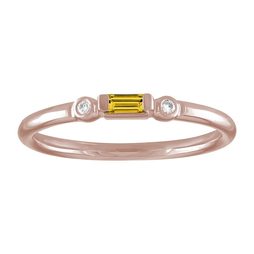 Rose gold skinny band with a citrine baguette in the center and two round diamonds on the side.