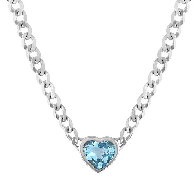 White gold cuban link chain necklace with a heart shaped bezeled blue topaz in the center.