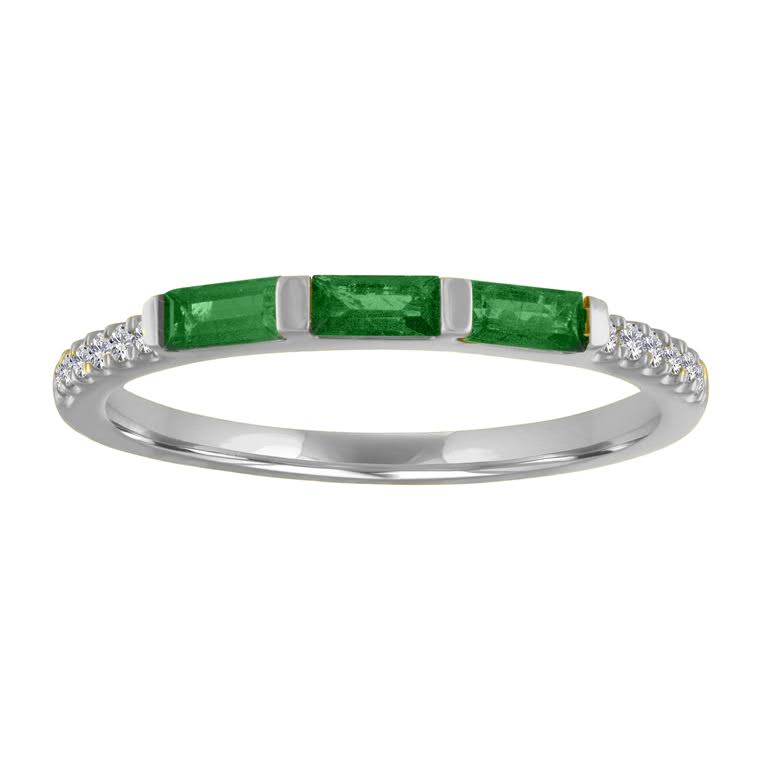 White gold skinny band with three emerald baguettes and round diamonds on the shank.