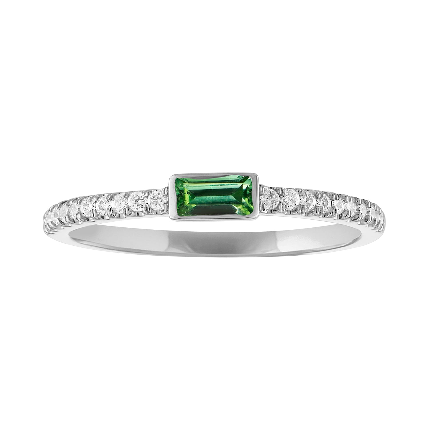 White gold skinny band with a bezeled emerald baguette in the center and round diamonds on the shank.