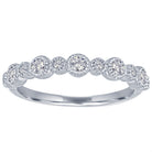 White gold skinny band with large round diamonds and small round diamonds.