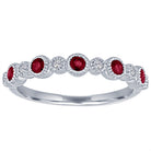 White gold skinny band with large round garnets and small round diamonds.
