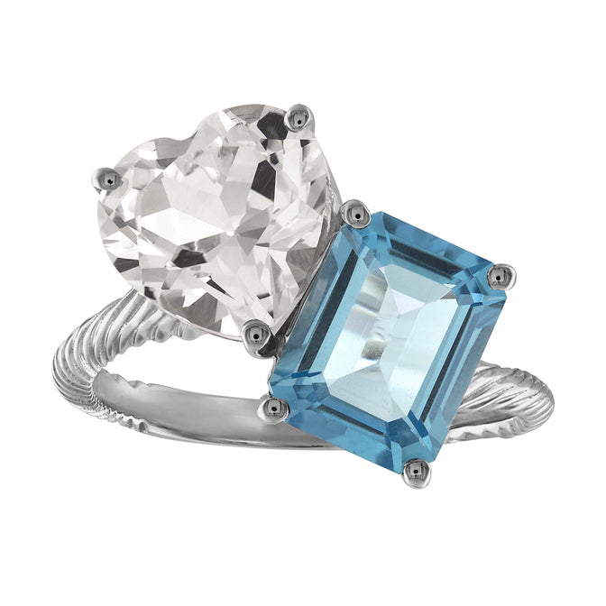 White gold two-stone ring with a blue topaz emerald cut and a white sapphire heart.
