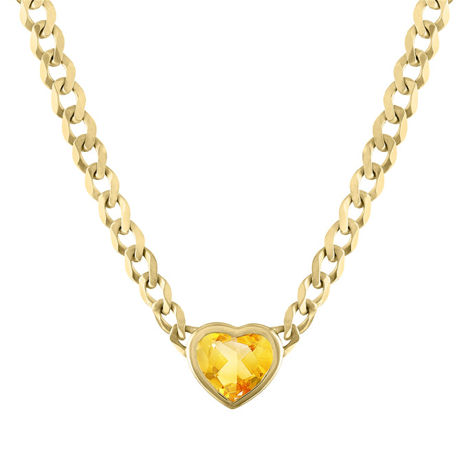 Yellow gold cuban link chain necklace with a heart shaped bezeled citrine in the center.