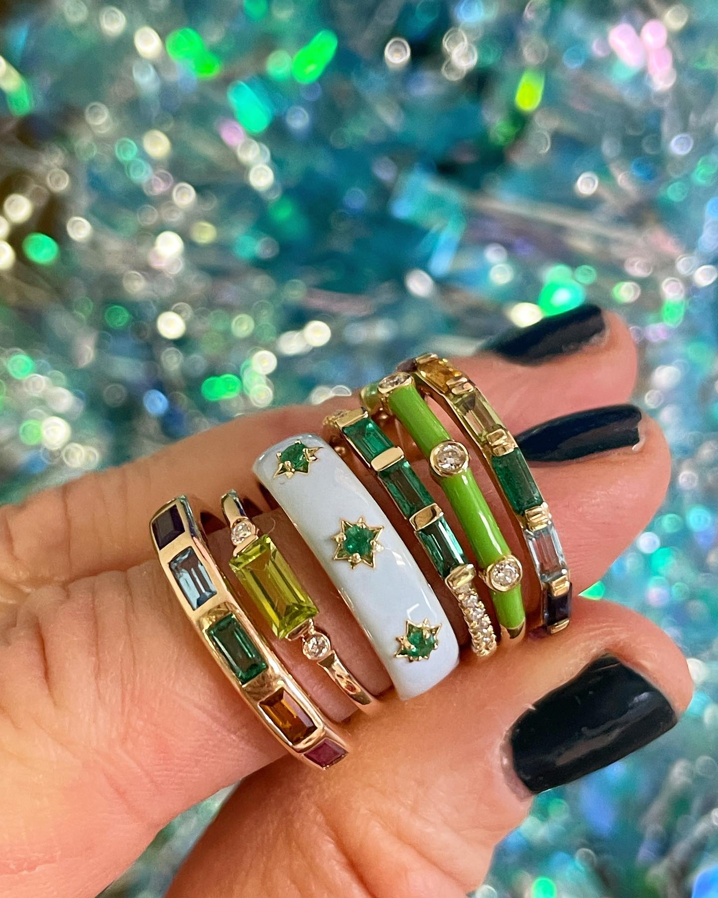 Gold gypsy ring with round emeralds and white enamel.