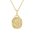 Yellow gold oval shaped necklace with fluting and a diamond initial in the center.