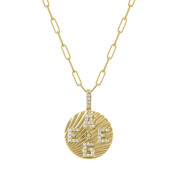Yellow gold round disc necklace with fluting and diamond initials.