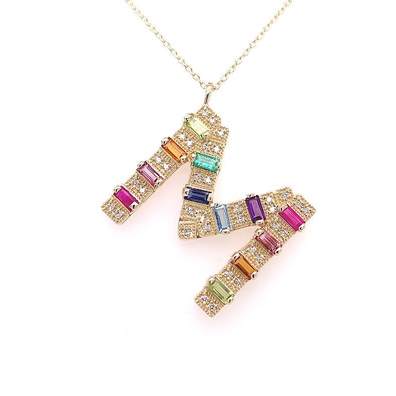 Yellow gold mini initial necklace with multicolor baguettes and round diamonds.