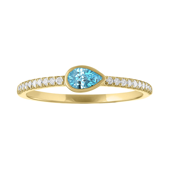 Yellow gold skinny band with a bezeled pear shape aquamarine in the center and round diamonds on the shank.