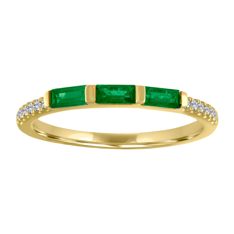 Yellow gold skinny band with three emerald baguettes and round diamonds on the shank.