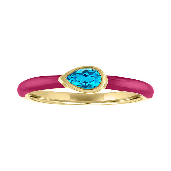 Yellow gold skinny band with fuchsia enamel and a bezeled pear shape blue topaz.