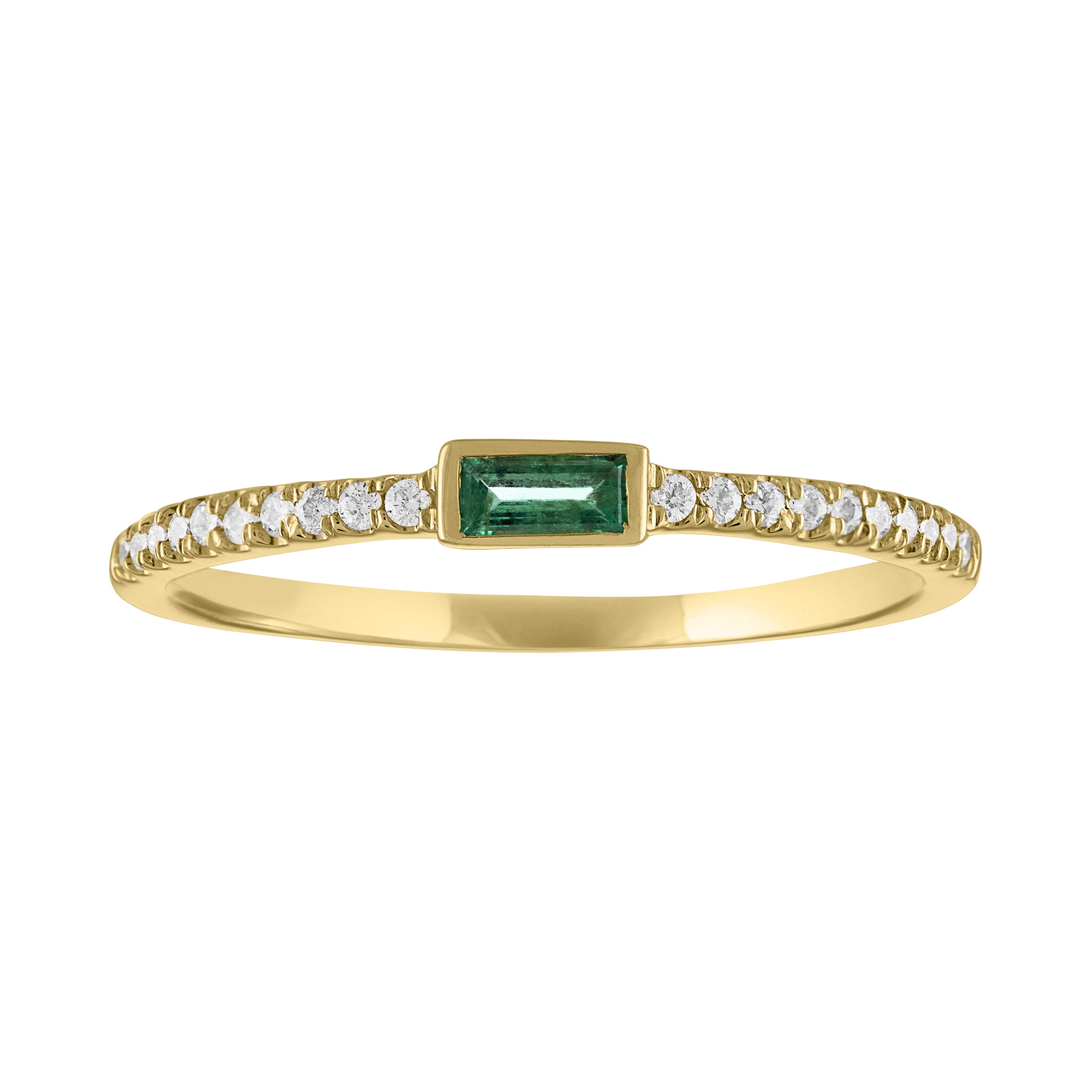 Yellow gold skinny band with a bezeled emerald baguette and round diamonds on the shank.