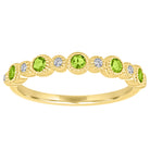 Yellow gold skinny band with large round peridots and small round diamonds.