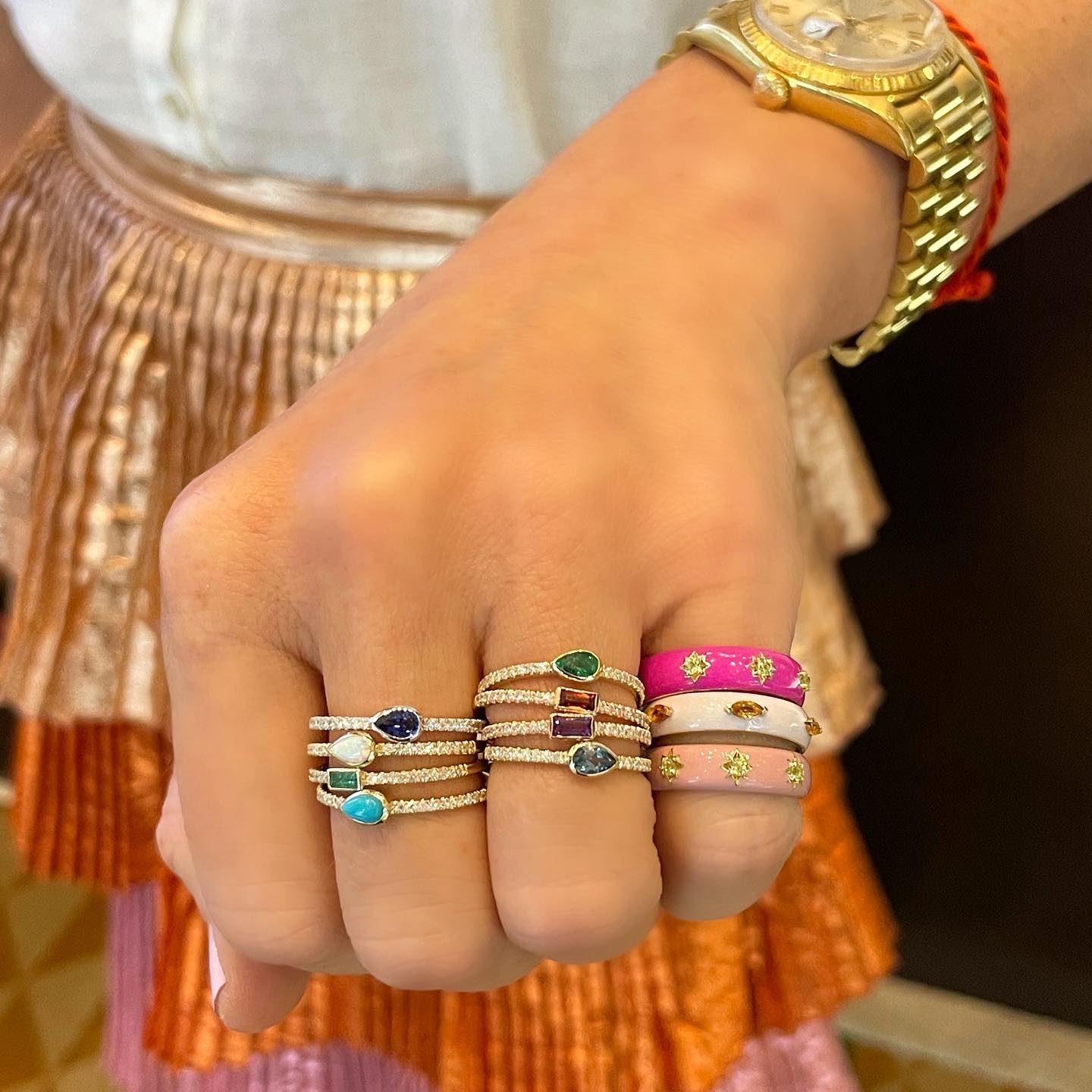 Wide band gold gypsy ring with white enamel and citrine marquise shown in a stack with a pop of color