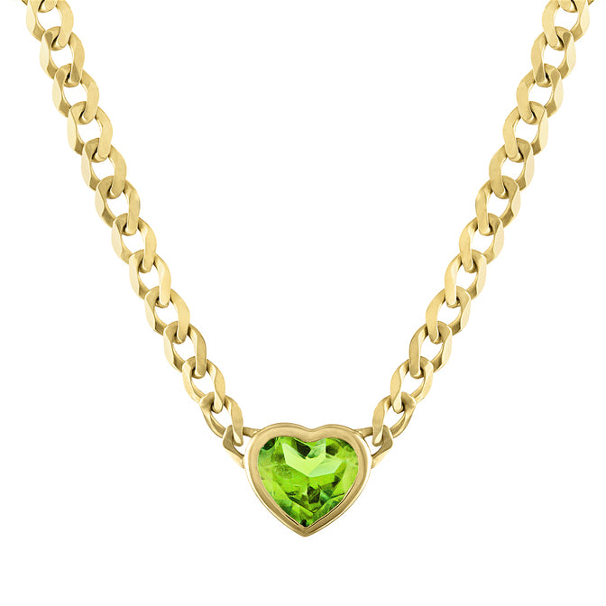 Yellow gold cuban link chain necklace with a heart shaped bezeled peridot in the center. 