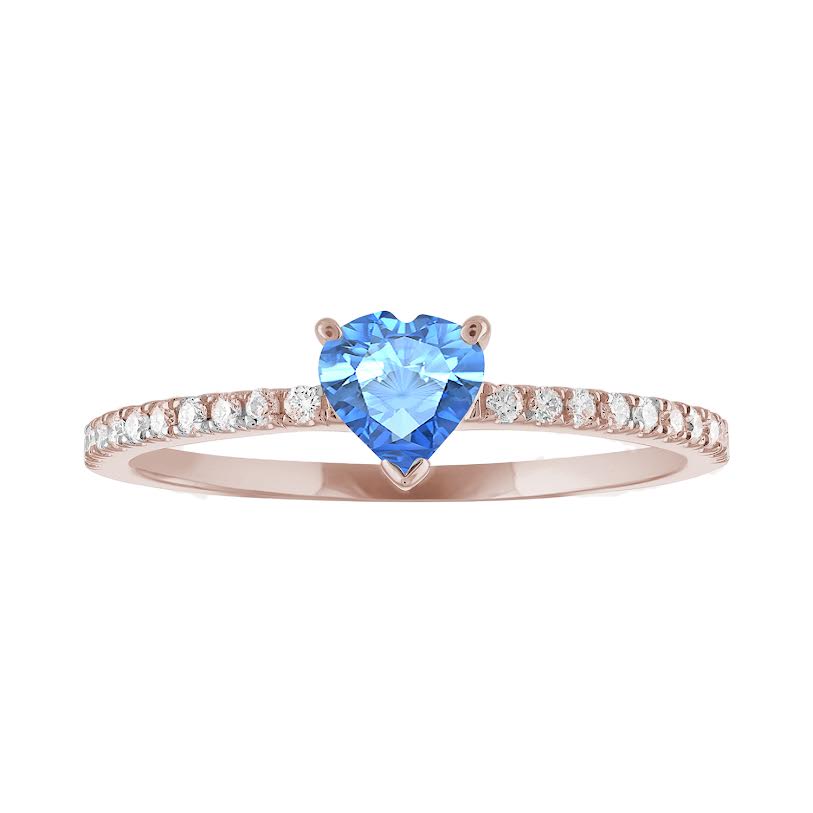 Thin banned rose gold ring with heart shaped blue topaz and round diamonds on the shank