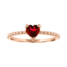 Rose gold beaded skinny band with a heart shaped garnet in the center. 