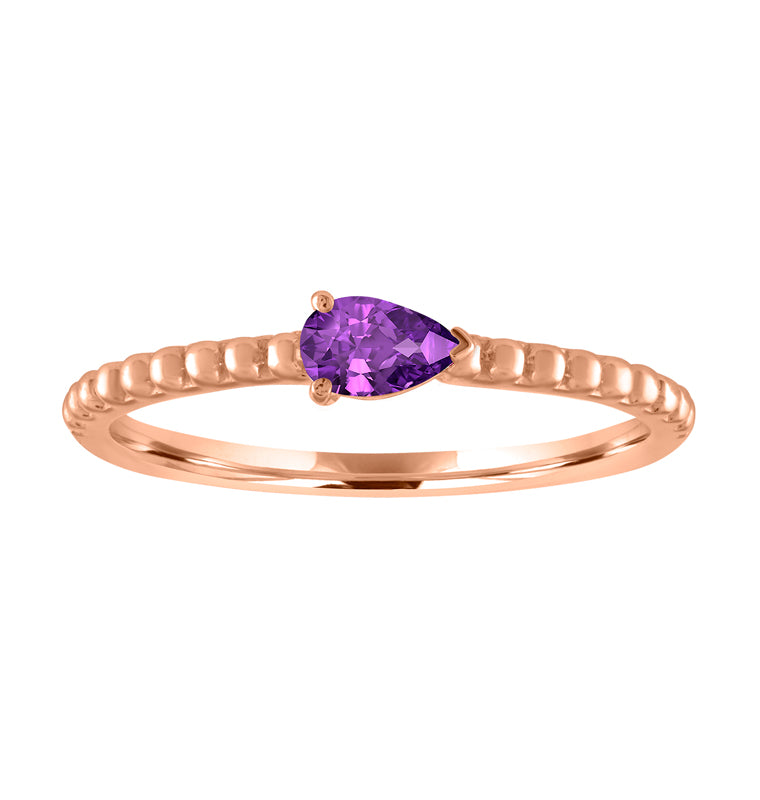 Rose gold beaded skinny band with a pear shaped amethyst in the center. 