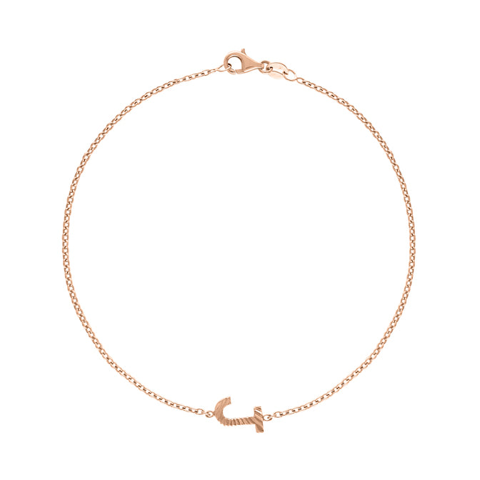 Rose gold bracelet with a small fluted initial in the middle.