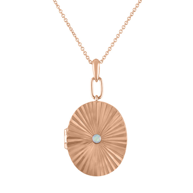 Rose gold pleated oval locket with a small round opal in the center. 