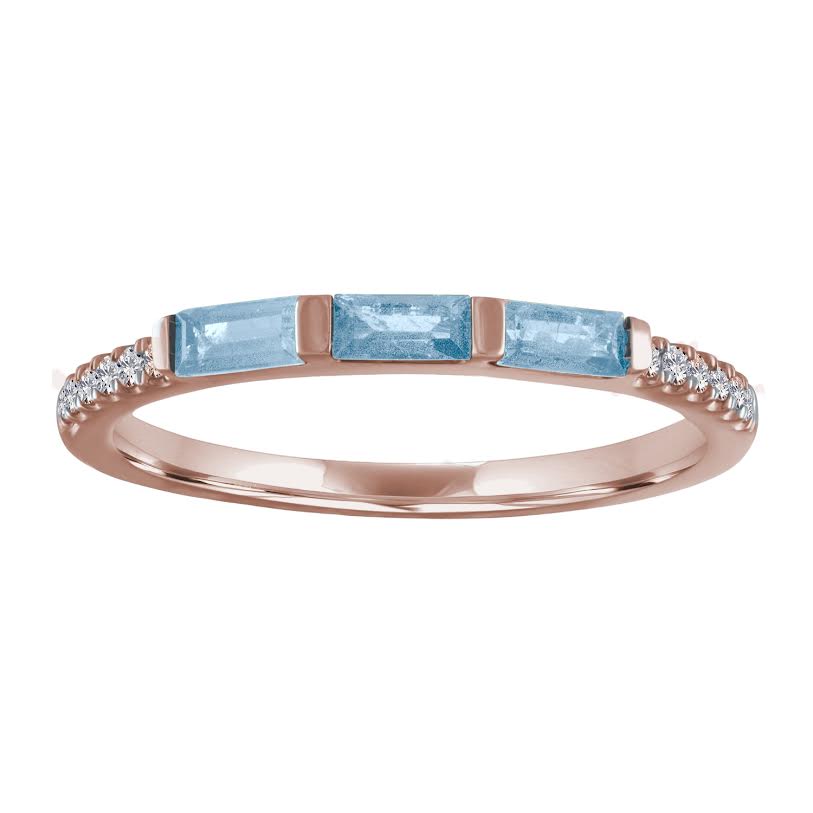 Rose gold skinny band with three aquamarine baguettes and round diamonds on the shank. 