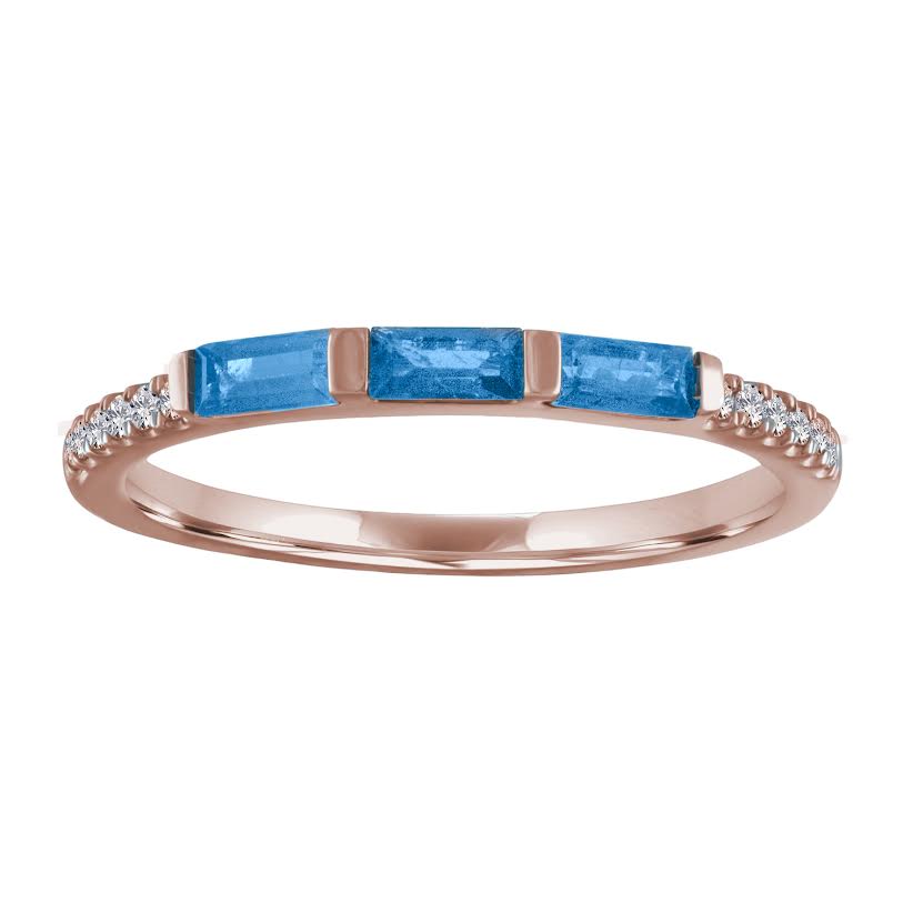 Rose gold skinny band with three blue topaz baguettes and round diamonds on the shank. 