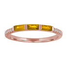 Rose gold skinny band with three citrine baguettes and round diamonds on the shank.