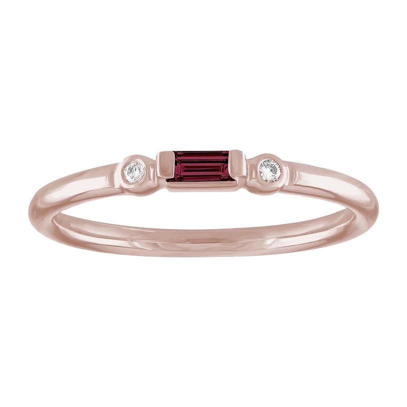 Rose gold skinny band with a garnet baguette in the center and two round diamonds on the side. 