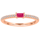 Rose gold skinny band with a ruby baguette in the center and round diamonds on the shank.