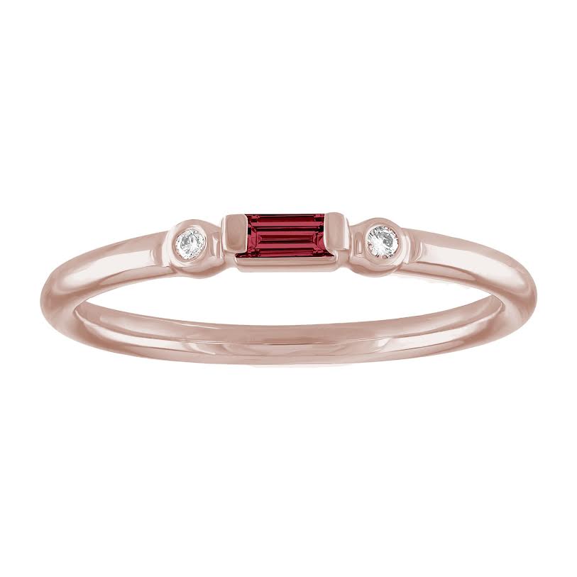 Rose gold skinny band with a ruby baguette in the center and two round diamonds on the side. 
