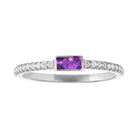 White gold skinny band with a bezeled amethyst baguette in the center and round diamonds on the shank.