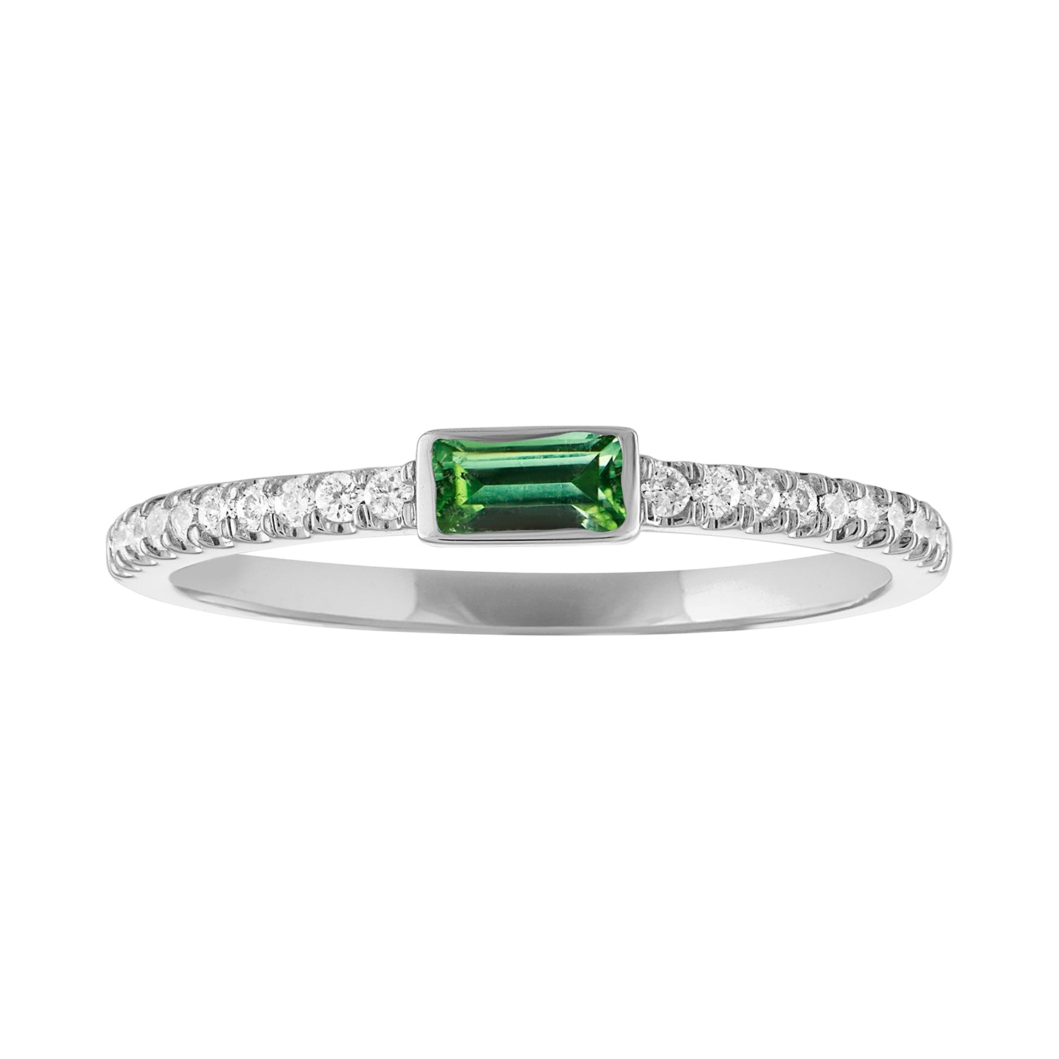 White gold skinny band with a bezeled emerald baguette in the center and round diamonds on the shank. 