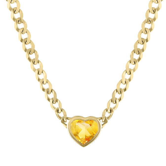 Yellow gold cuban link chain necklace with a heart shaped bezeled citrine in the center. 
