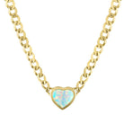 Yellow gold cuban link chain necklace with a heart shaped bezeled opal in the center. 