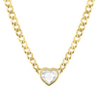 Yellow gold cuban link chain necklace with a heart shaped bezeled white topaz. 