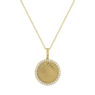 Yellow gold round disc necklace with fluting and round diamonds along the border.