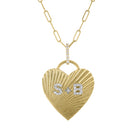 Yellow gold fluted heart charm with diamond initials, a diamond bail and a paperclip chain.