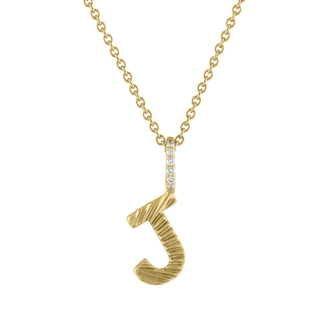 Yellow gold mini initial necklace with fluting and a diamond bail. 