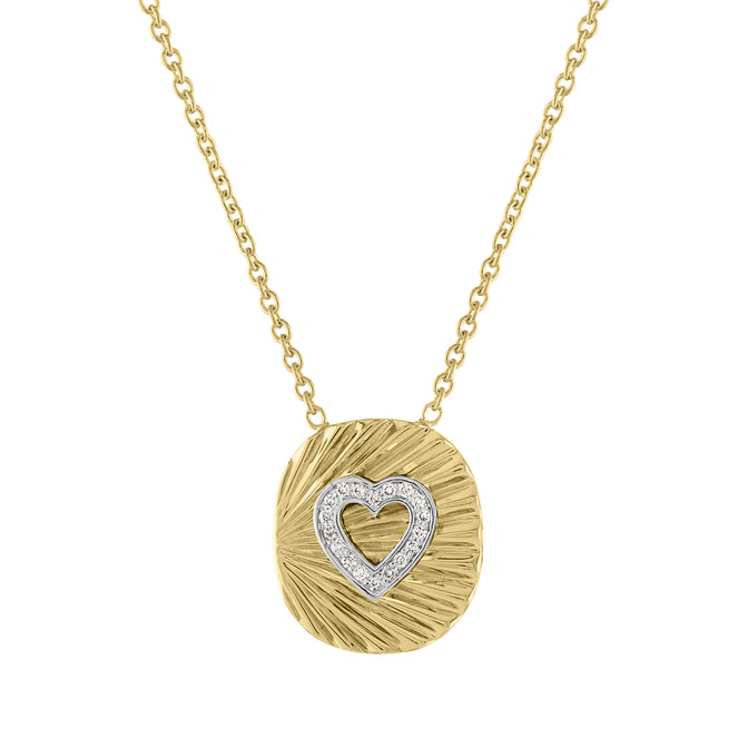 Yellow gold oval necklace with fluting and a diamond heart in the center. 