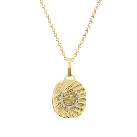 Yellow gold fluted oval shaped necklace with a diamond horseshoe in the center. 