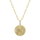 Yellow gold round disc necklace with fluting and diamond initials. 