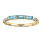 Yellow gold skinny band with three aquamarines baguettes and round diamonds on the shank. 