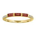 Yellow gold skinny band with three garnet baguettes and round diamonds on the shank. 